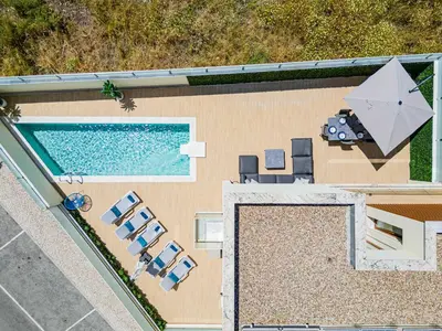 a glass staircase in a house with wooden floors at Villa La Colline I Private Pool Oasis Near Old Town in Albufeira