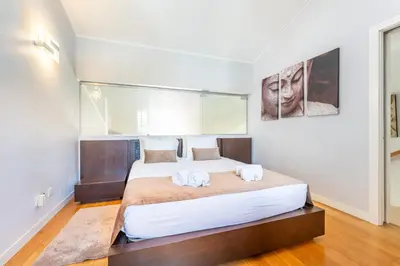 a bedroom with a large bed with two towels at Casa da Paz by Algarve Holidays in Albufeira