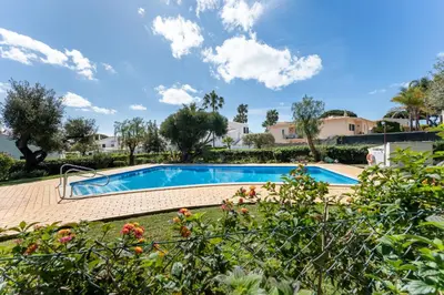 a swimming pool in a yard with trees at Casa da Paz by Algarve Holidays in Albufeira