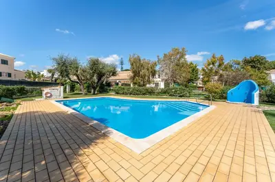 a swimming pool in a yard with a brick patio at Casa da Paz by Algarve Holidays in Albufeira