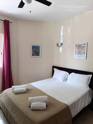 a bedroom with a large bed with two towels on it at Casa Gomez A in Albufeira
