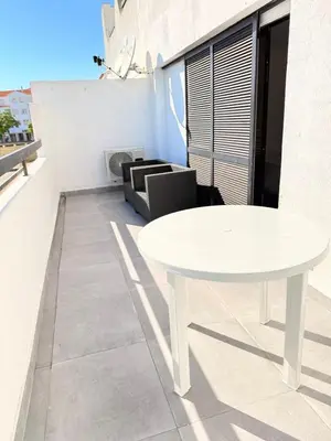 a white table on the balcony of a room at OuraFlats in Albufeira