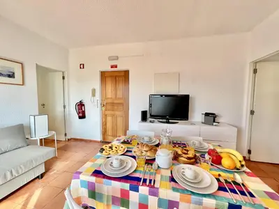 a living room with a table with food on it at Albufeira Skylight 2 With Pool by Homing in Albufeira