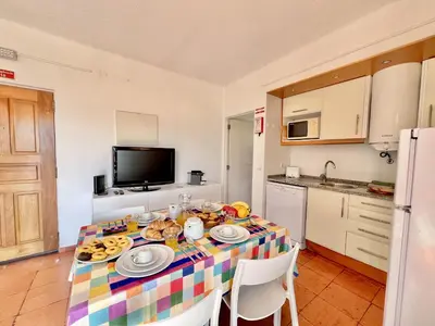 a kitchen with a table with plates of food on it at Albufeira Skylight 2 With Pool by Homing in Albufeira