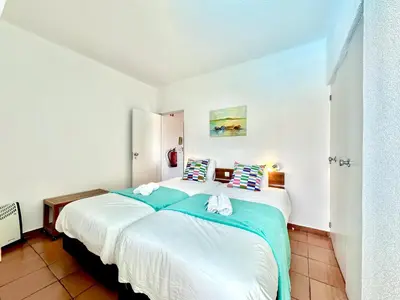 a bedroom with a large white bed with pillows at Albufeira Skylight 2 With Pool by Homing in Albufeira