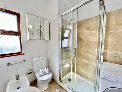 a bathroom with a shower and a toilet at Albufeira Skylight 2 With Pool by Homing in Albufeira