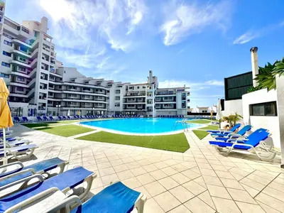 a resort with a swimming pool and lounge chairs at Albufeira Skylight 2 With Pool by Homing in Albufeira