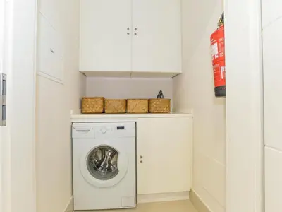 a laundry room with a washer and dryer at Apartment Pine Hills Reva Santuary Modern Elegance by Interhome in Vilamoura