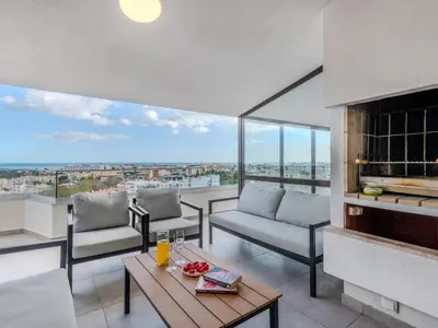 a living room with a couch and a fireplace at Apartment Villa Magna by Interhome in Albufeira