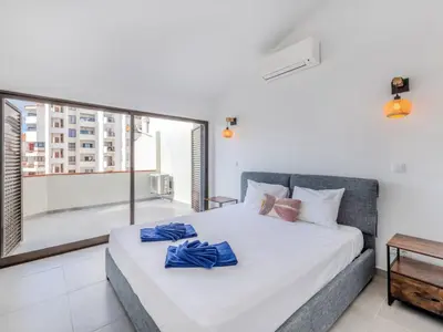 a bedroom with a bed and a large window at Apartment Villa Magna by Interhome in Albufeira
