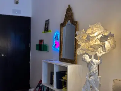 a mirror sitting on a shelf next to a statue at no22FM in Vilamoura