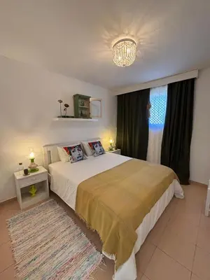 a bedroom with a large bed and a chandelier at no22FM in Vilamoura