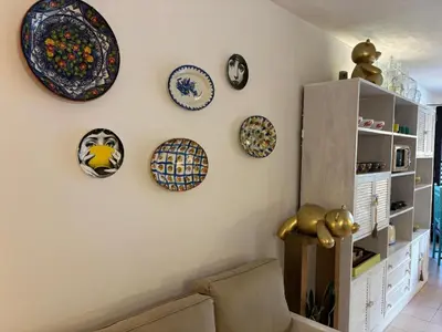 a living room with plates on the wall at no22FM in Vilamoura