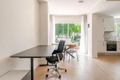 a kitchen and dining room with a table and chairs at Casa Eden 2BR modern Apartment near Marina! Patio-Porch-WS-BBQ-FAST WIFI! in Quarteira