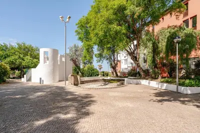 a street with trees and a building and a street light at Casa Eden 2BR modern Apartment near Marina! Patio-Porch-WS-BBQ-FAST WIFI! in Quarteira