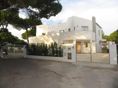a white house with a fence in front of it at Luxury Villa with Private pool walking distance to beach and Marina in Quarteira