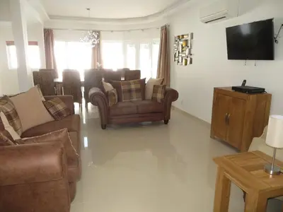 a living room with couches and a flat screen tv at Luxury Villa with Private pool walking distance to beach and Marina in Quarteira