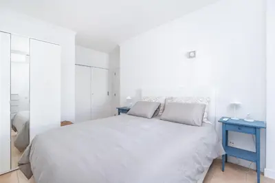 a kitchen with wooden cabinets and a window at BnB Homes Apartments near Ocean & Lush Nature 500 m away from the ocean in Guia