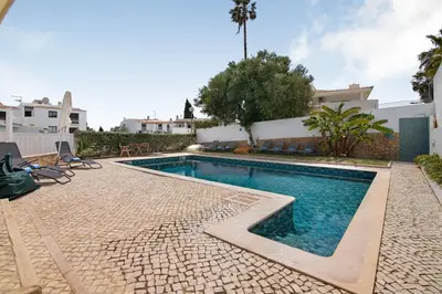 a white building with a door and a courtyard at Al´Corais in Albufeira