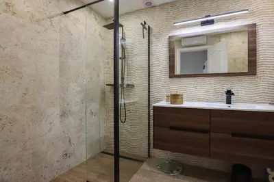 a bathroom with a shower and a sink and a mirror at Jardins do Castelo - Piscina e tranquilidade - BY BEDZY in Albufeira