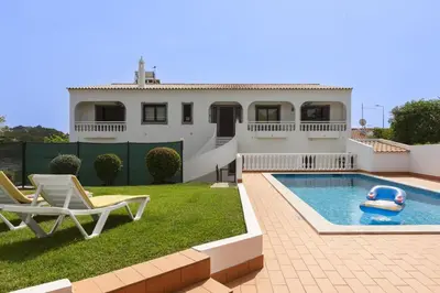 a house with a pool and a toy in the yard at Vila de santa Eulalia II - Albufeira in Albufeira