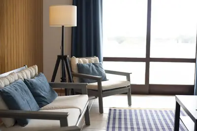 a living room with two chairs and a couch and a lamp at Vila de santa Eulalia II - Albufeira in Albufeira