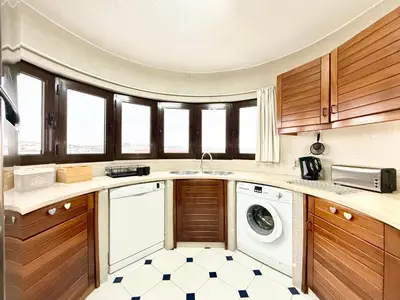 a kitchen with a washer and dryer at Home Out Albufeira - T1 Oura in Albufeira