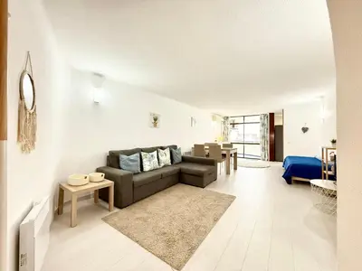a living room with a couch and a table at Home Out Albufeira - T1 Oura in Albufeira