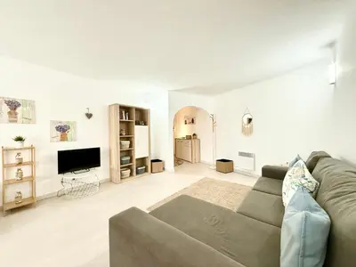 a living room with a couch and a flat screen tv at Home Out Albufeira - T1 Oura in Albufeira
