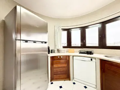 a kitchen with a refrigerator and a sink at Home Out Albufeira - T1 Oura in Albufeira