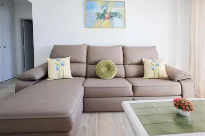 a living room with a brown couch and a table at Vista Azul - 500 from the beach - AC - BY BEDZY in Albufeira