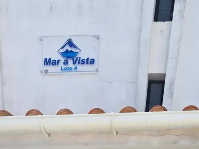 a sign on the side of a building at Vista Azul - 500 from the beach - AC - BY BEDZY in Albufeira