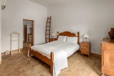 a bedroom with a bed and a ladder and a mirror at True Local Village in Loulé