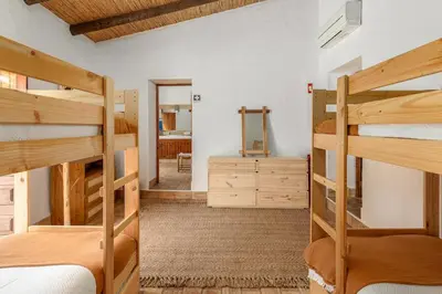 a bedroom with two bunk beds and a mirror at True Local Village in Loulé