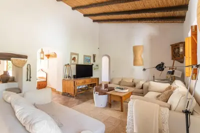 a living room with a couch and a tv at True Local Village in Loulé