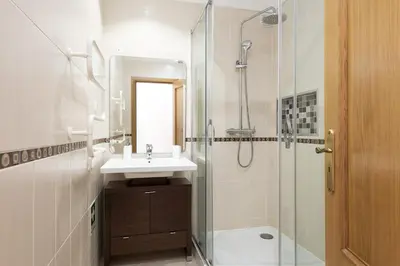 a bathroom with a sink and a glass shower at Praia Village II - Peaceful condominium by HD in Vilamoura