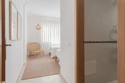 a hallway leading to a room with a table at Praia Village II - Peaceful condominium by HD in Vilamoura
