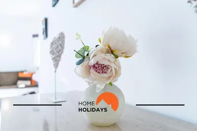a white vase with flowers in it on a table at #314 T2 Serenity by Home Holidays in Albufeira