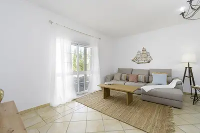 a hallway with white walls and stone stairs at Villa Menina by Ocvillas in Albufeira