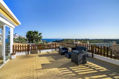 a balcony with benches and a view of the ocean at Villa Sitambo- Pool & Sea View in Albufeira