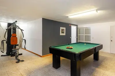 a room with a pool table and a camera at Villa Sitambo- Pool & Sea View in Albufeira