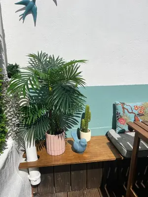 a table with potted plants on it next to a couch at casa da vila 33 in Faro