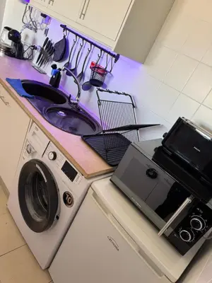 a kitchen with a washing machine and a sink at Albufeira Cozy Sea View with Balcony & Resort Access in Albufeira