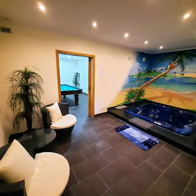 a living room with a swimming pool and a painting at Villa Ocean Gale in Albufeira