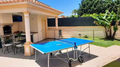 a ping pong table in the backyard of a house at Villa Ocean Gale in Albufeira