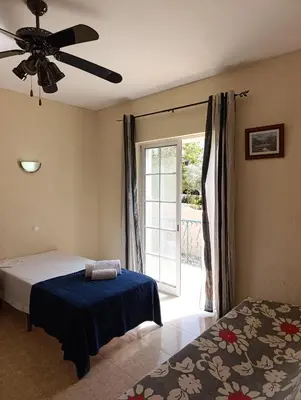 a bedroom with a bed and a ceiling fan at Casa Gomez B in Albufeira