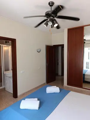 a bedroom with a bed with a ceiling fan at Casa Gomez B in Albufeira