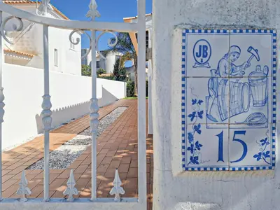 a tile of a man drinking from a barrel on a wall at 2 Vale de Ursa - Swimming Pool - WIFI - BY BEDZY in Guia