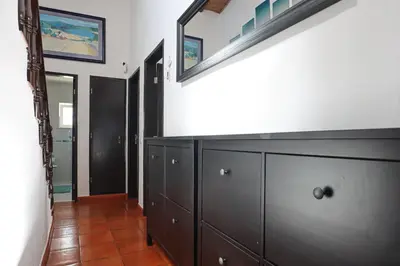 a hallway with a wooden dresser and a mirror at 2 Vale de Ursa - Swimming Pool - WIFI - BY BEDZY in Guia