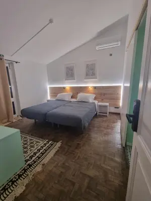 a bedroom with a large bed in a room at Wonder Charm Guesthouse in Albufeira